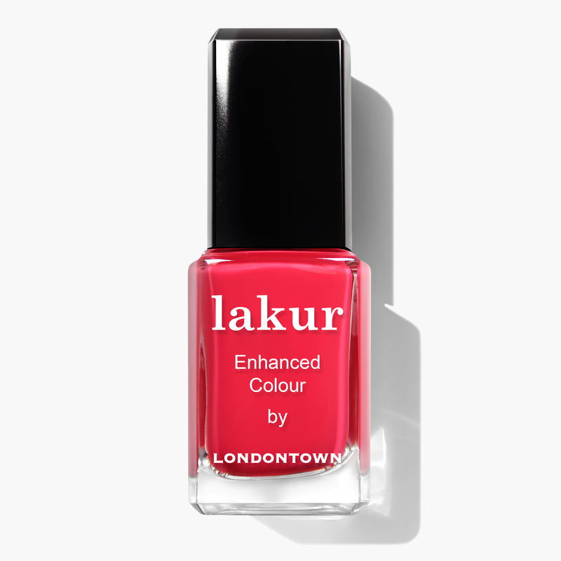 A bottle of LONDONTOWN's London Calling Lakur vegan, cruelty-free nail polish in a bright pink shade with a sleek black cap.