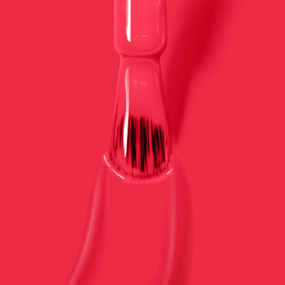 Close-up of a brush applying "London Calling (Professional)" bright red, cruelty-free nail polish from LONDONTOWN, with glossy, even coverage visible on the bristles and surrounding area.