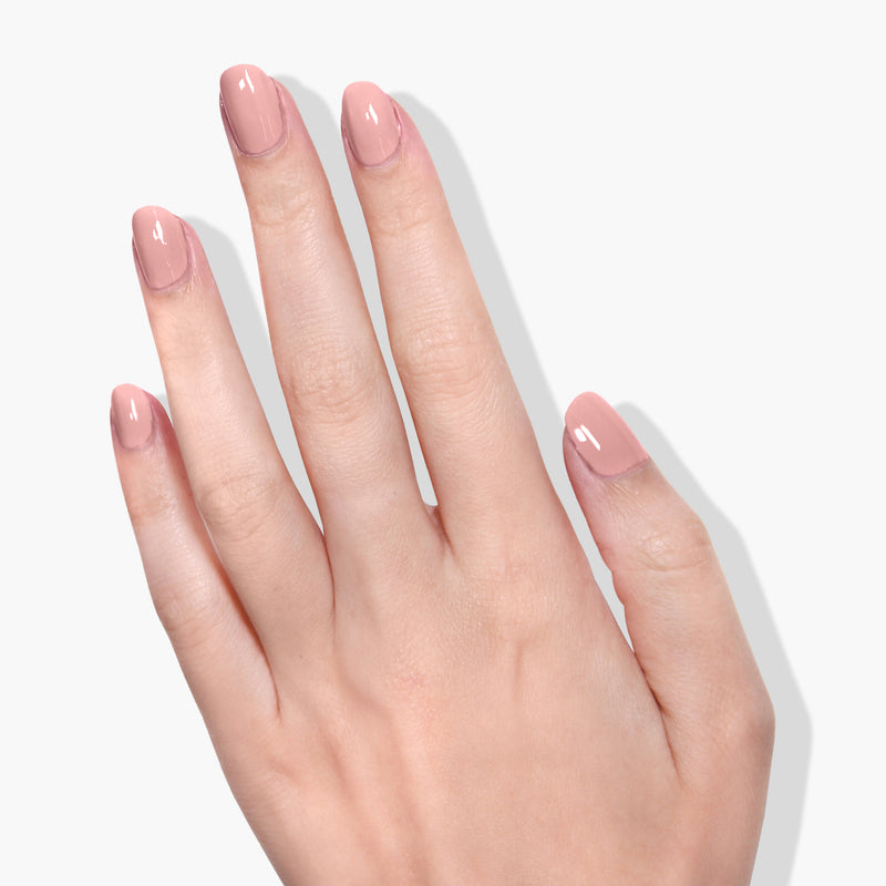 A hand with nails polished in LONDONTOWN's Mauve Over, featuring a high-shine formula UV/LED Gel Color, is shown against a plain white background.