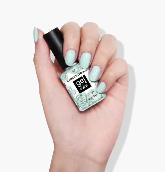 Hand holding a bottle of LONDONTOWN Mint No Chip vegan UV/LED Gel Color nail polish in a refreshing mint creme shade.