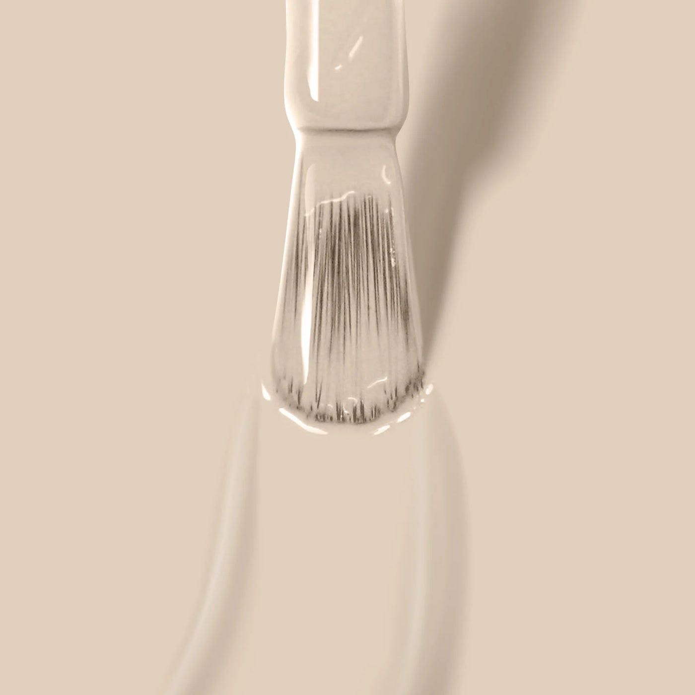 Close-up of a LONDONTOWN Murray Me (Professional) brush applying a smooth, French Vanilla Cream nail polish stroke.