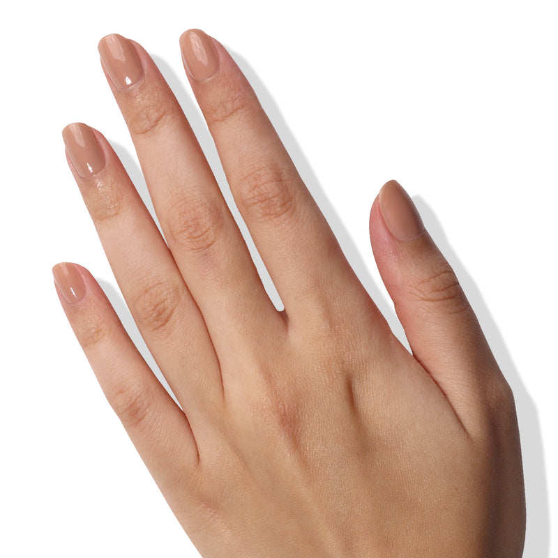 A hand with neatly manicured nails, painted in LONDONTOWN's Perfecting Nail Veil #6 for a subtle hint of color, is shown against a white background.