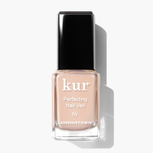 A bottle of LONDONTOWN's Perfecting Nail Veil #1, featuring a square-shaped black cap and a label displaying the product name on a translucent, peach-colored liquid. This power-packed nail veiling solution offers both color and care for your nails.