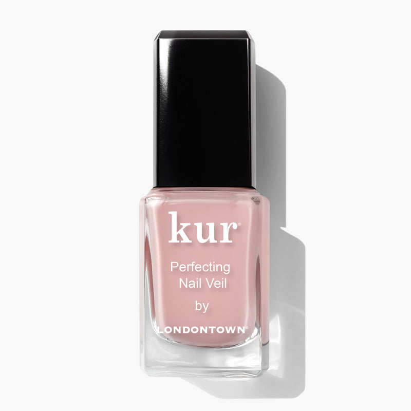 A bottle of LONDONTOWN Perfecting Nail Veil #4 nail polish with a black cap and light pink liquid inside, giving a hint of color, photographed against a white background.