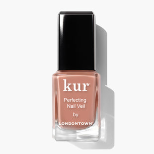 A bottle of LONDONTOWN Perfecting Nail Veil #5 in a peachy nude shade, power-packed with color and care, featuring a sleek black cap, displayed against a white background.