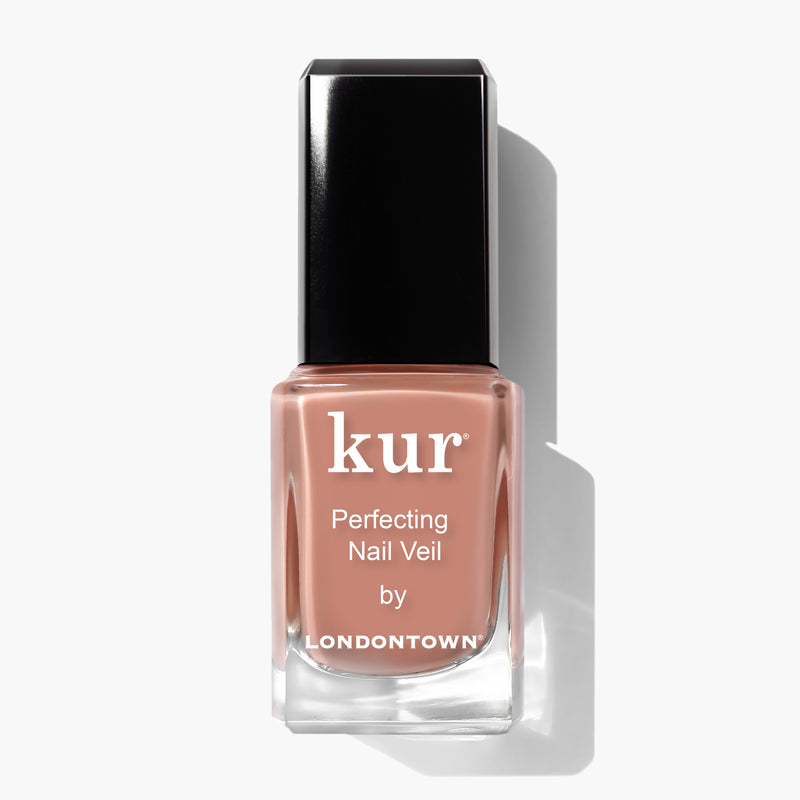 A bottle of LONDONTOWN Perfecting Nail Veil #5 in a peachy nude shade, power-packed with color and care, featuring a sleek black cap, displayed against a white background.