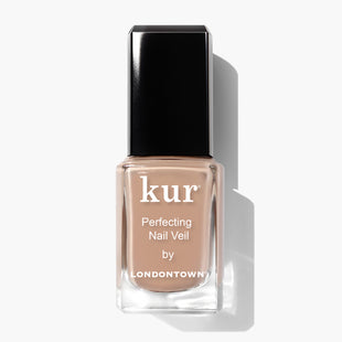 A rectangular bottle of Perfecting Nail Veil #6 by LONDONTOWN, featuring a hint of color with its nude nail polish, complemented by a black cap and white text on the label. This power-packed product offers both beauty and care for your nails.