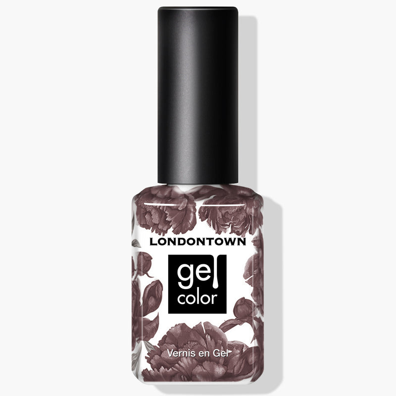 A bottle of LONDONTOWN's "Natural Charm" Gel Color nail polish in a creamy mauve purple shade, featuring a floral-patterned label and black cap. The text on the label reads "LONDONTOWN Gel Color Vernis en Gel." This vegan, cruelty-free formula ensures beautiful nails without compromise.