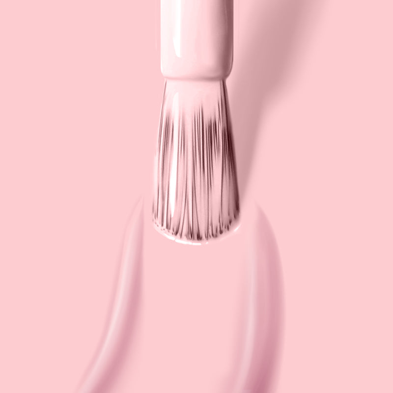 Close-up of the LONDONTOWN "Out of Office" nail polish brush applying pastel pink, vegan cruelty-free nail polish on a matching pink background.