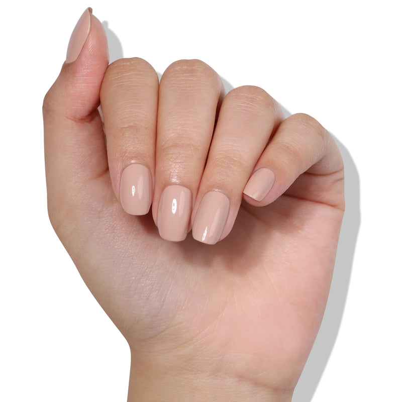 A hand with neatly manicured fingernails painted in a creamy Pampas Beige by LONDONTOWN.