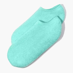 A pair of Pedi Perfect Moisturizing Spa Socks in light blue by LONDONTOWN, promising cozy feet, isolated on a white background.