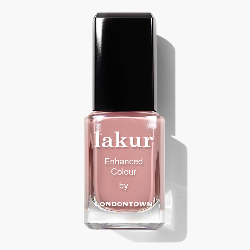 A bottle of LONDONTOWN Pink Sands Nail Polish with a pink hue, Florium Complex infused, and a black cap. This vegan, cruelty-free formula ensures long-lasting color while being kind to your nails.