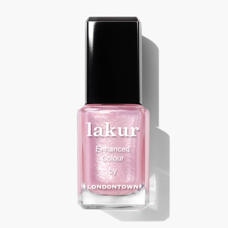 A bottle of LONDONTOWN's Pink Strawberry Lakur Enhanced Colour nail polish in sweet baby pink, featuring ultrafine glitter. The cap is black, and the product is shot against a plain white background.