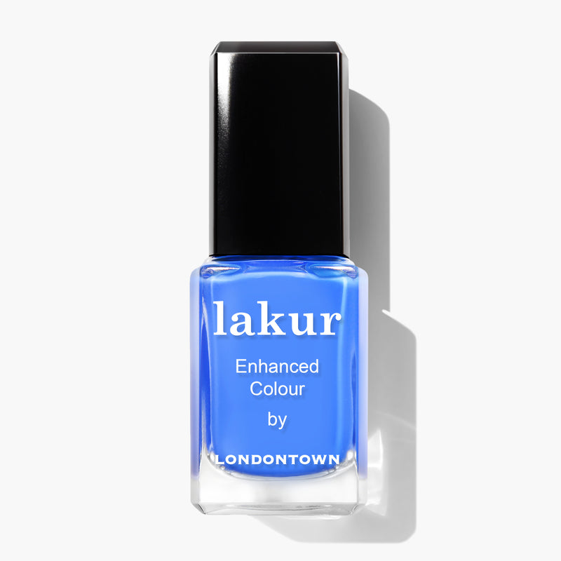 A bottle of blue nail polish labeled "Poolside Dreams by LONDONTOWN" with a black cap, displayed against a white background. This cruelty-free, vegan formula ensures your nails look stunning while staying kind to the planet.