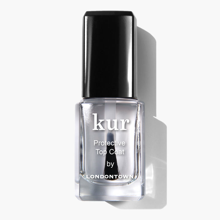 A bottle of LONDONTOWN Protective Top Coat nail polish, celebrated for its chip-resistant, ultra-glossy finish, featuring a black cap and white label against a white background.