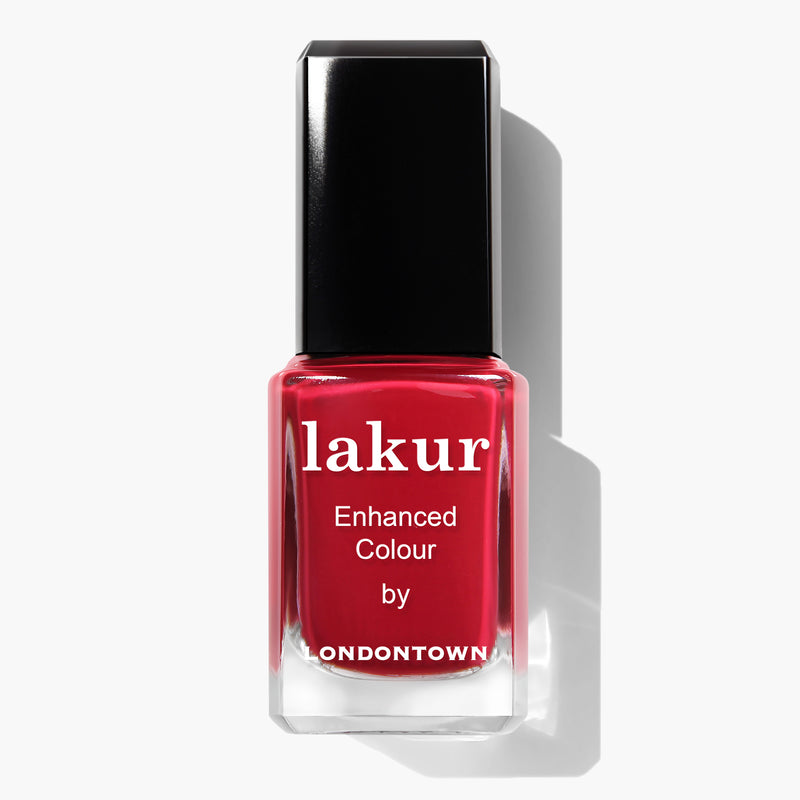 A bottle of red crème Lakur Enhanced Colour nail polish named "Ring Me" by LONDONTOWN, PETA certified and vegan cruelty-free, with a black cap.