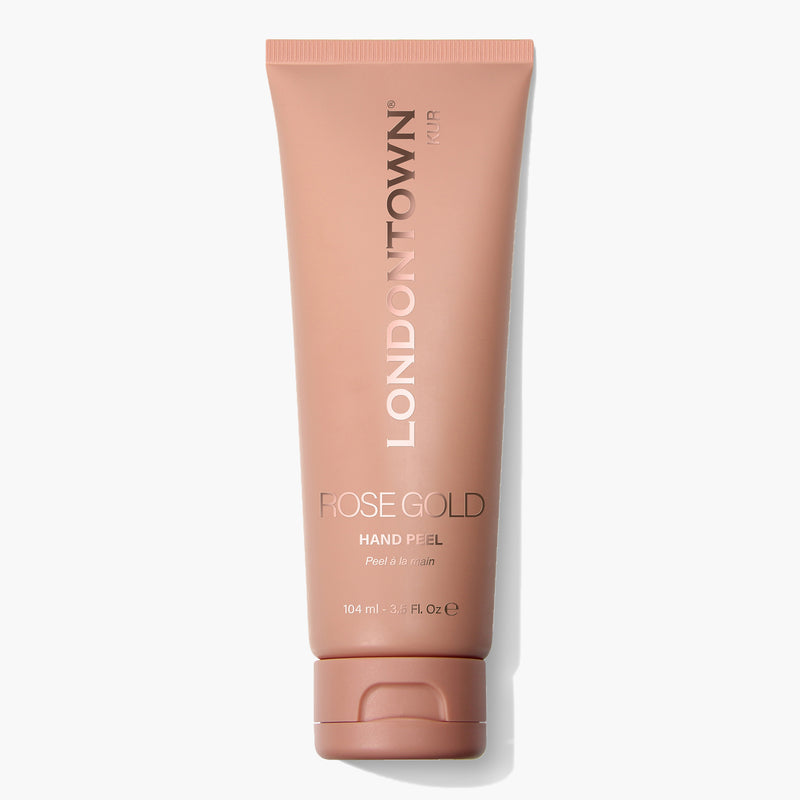 A 104ml tube of LONDONTOWN's Rose Gold Hand Peel featuring a pinkish-brown cap and label. The packaging displays the text "Peel & Serum." This transformative mask promises brighter, softer hands.
