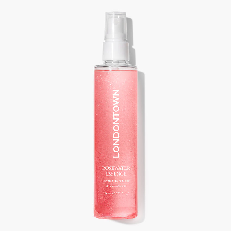A clear bottle with the label "LONDONTOWN Rosewater Essence Facial Mist" containing pink, rose-infused liquid. The bottle features a spray nozzle and holds 100 ml (3.38 fl oz) of product, providing a cloud of refreshing hydration.
