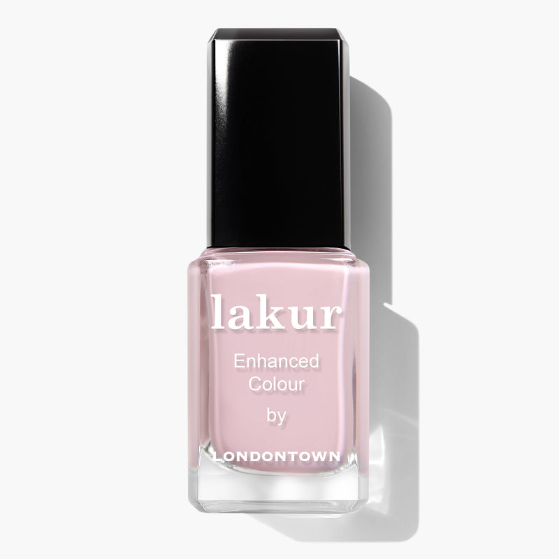 A bottle of LONDONTOWN Rosewater Lakur Enhanced Colour nail polish in light pink with a black cap, offering a vegan and cruelty-free formula.