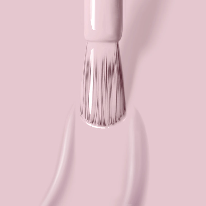 Close-up of a cruelty-free LONDONTOWN Rosewater nail polish brush applying pale pink nail polish.