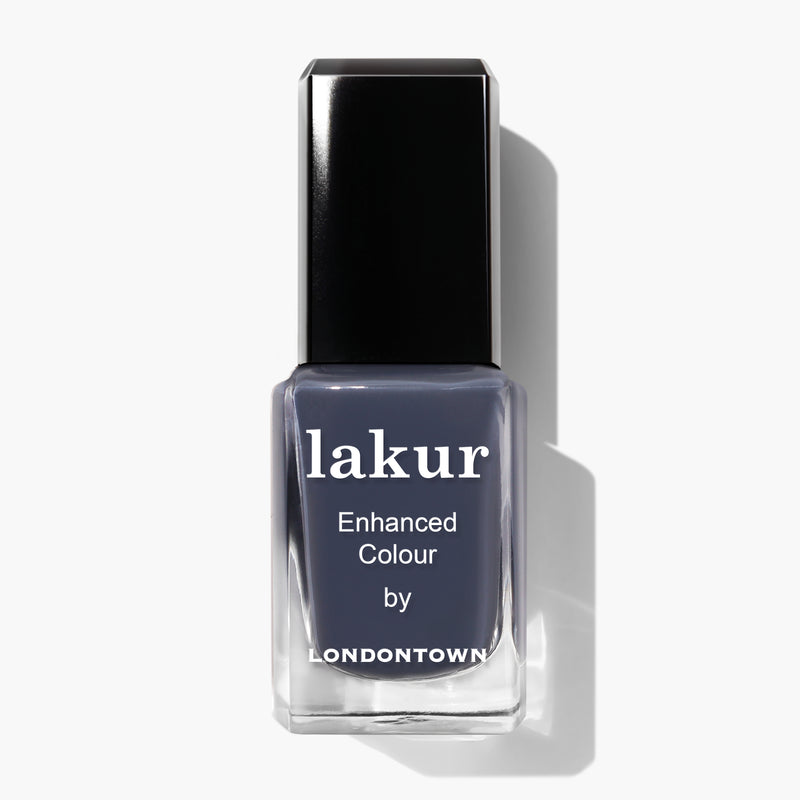 A square bottle of Secret to Happiness nail polish by LONDONTOWN, featuring a black cap and filled with a moody, cashmere-grey polish.