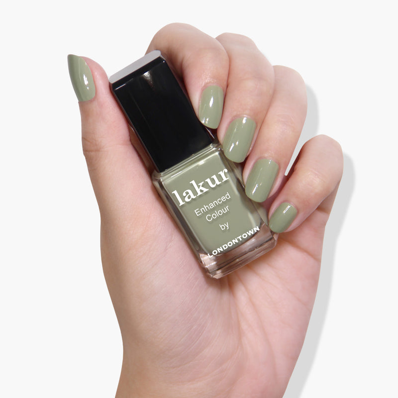 Hand holding a bottle of Sedona nail polish with succulent jade green painted nails. The bottle is labeled "lakur Enhanced Colour by LONDONTOWN." This vegan cruelty-free formula ensures a perfect, guilt-free manicure every time.