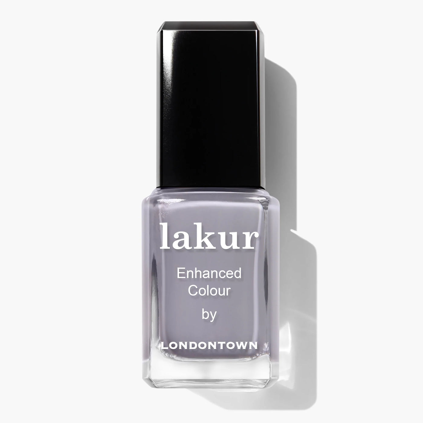 A bottle of LONDONTOWN's Silver Birch (Professional) nail polish with a black cap and "Enhanced Colour" written on the label. The muted, light grey shade perfectly complements the crisp vibe of autumn air. This vegan, cruelty-free nail polish ensures beauty with a conscience.