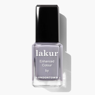 A bottle of LONDONTOWN's Silver Birch (Professional) nail polish with a black cap and "Enhanced Colour" written on the label. The muted, light grey shade perfectly complements the crisp vibe of autumn air. This vegan, cruelty-free nail polish ensures beauty with a conscience.