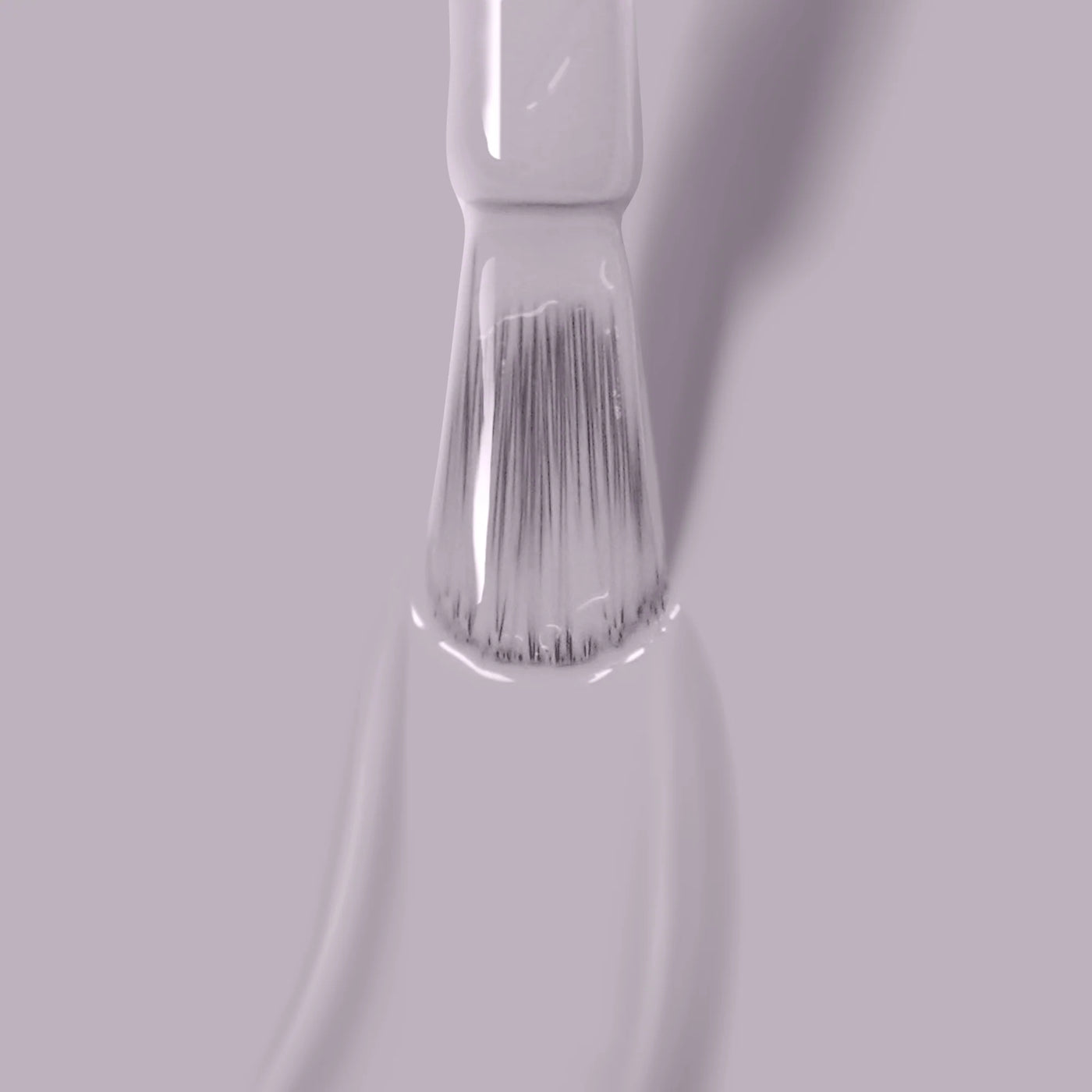 A close-up of a brush applying Silver Birch (Professional), a light gray, formaldehyde-free paint by LONDONTOWN, on a smooth surface.