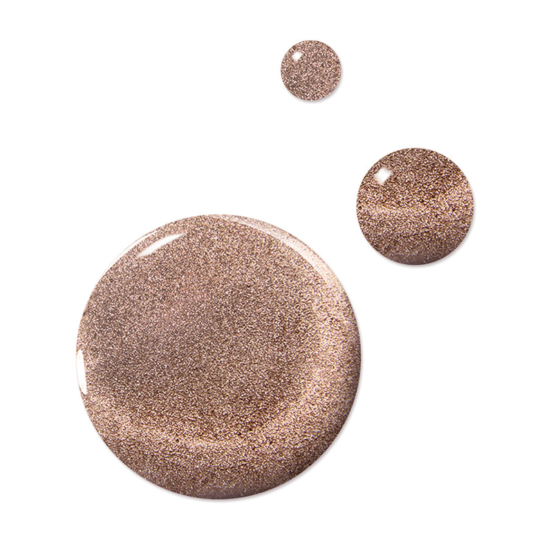 Three drops of LONDONTOWN's Sugarcane, a shimmery, cruelty-free bronze liquid, against a white background.