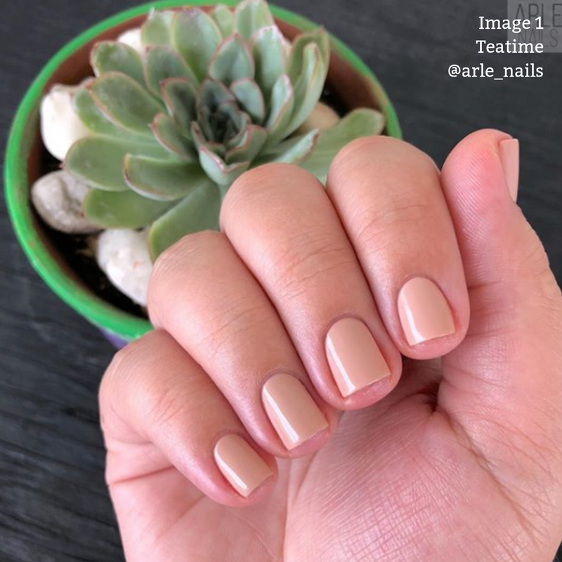 A hand with neatly manicured, short, sheer barely-there nude nails is shown holding a small potted succulent plant. Text in the upper right corner reads: "Image 1, LONDONTOWN Teatime, @arle_nails.
