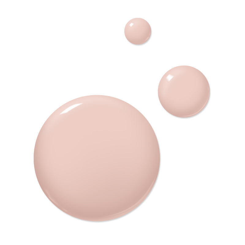 Three beige liquid blobs of varying sizes are scattered against a white background, resembling spills from a bottle of LONDONTOWN's Uncovered polish.