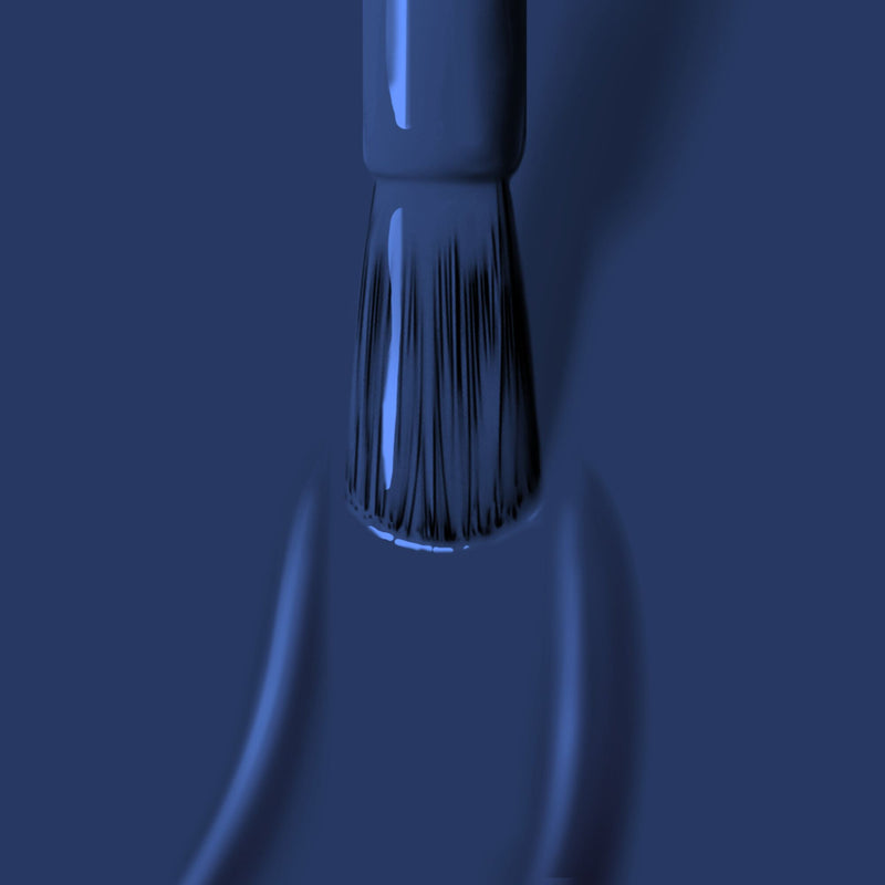 Close-up of a LONDONTOWN Under The Stars paintbrush with perfectly worn, blue bristles applying blue paint. The brush is depicted vertically.