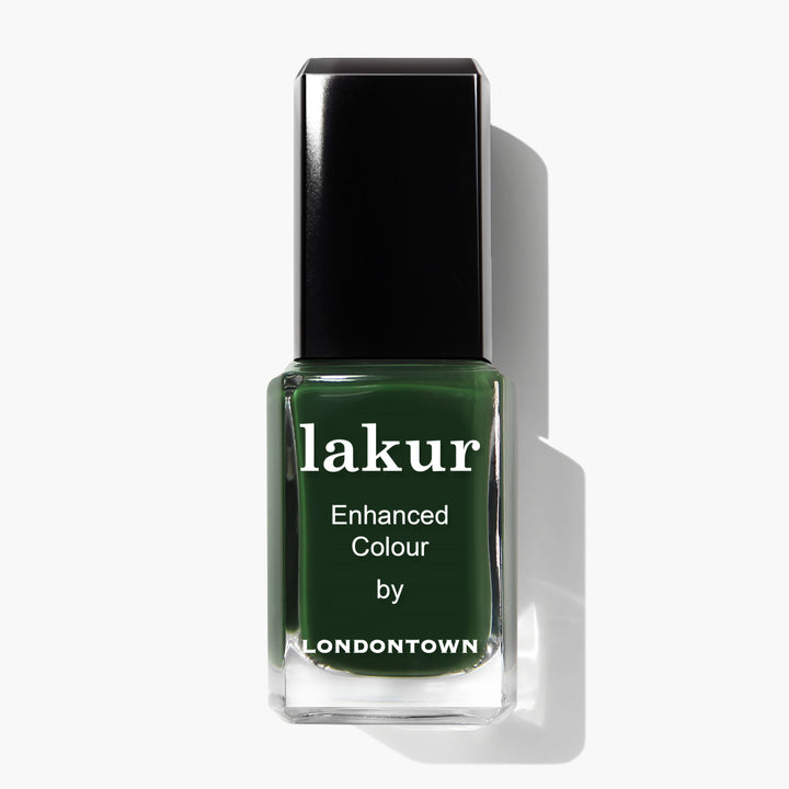A bottle of Vibe nail polish by LONDONTOWN in a rich jade green shade is displayed against a white background.