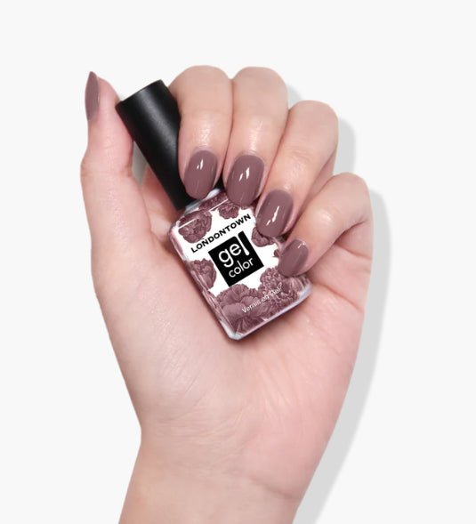 Hand holding a bottle of LONDONTOWN Bell Flower UV/LED Gel Color nail polish with matching vegan, dusty pink nail color.