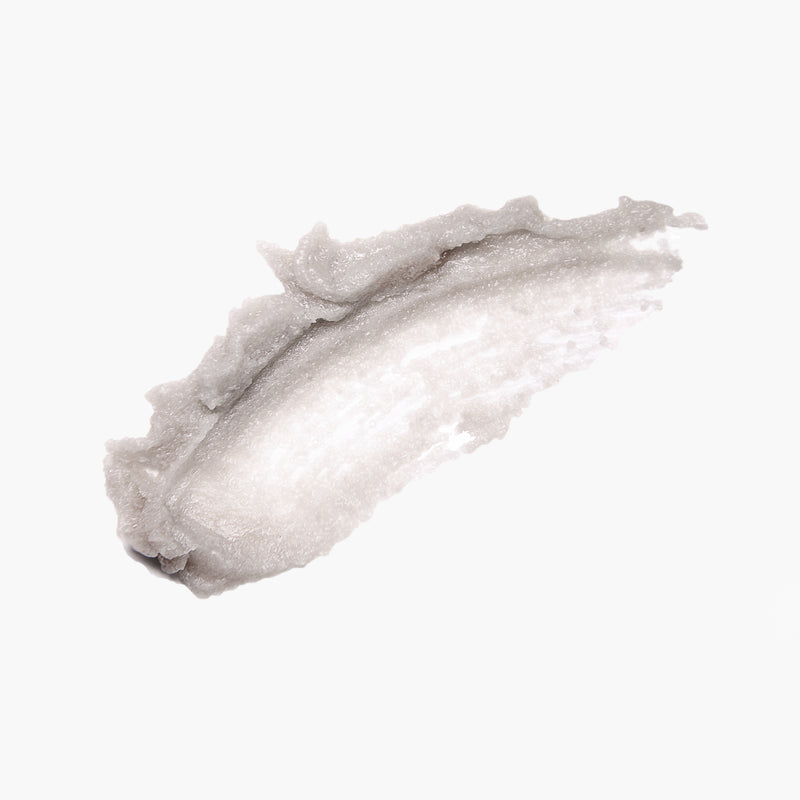 A smear of LONDONTOWN Foot Scrub with a pearlescent sheen and natural sugar crystals on a plain white background.